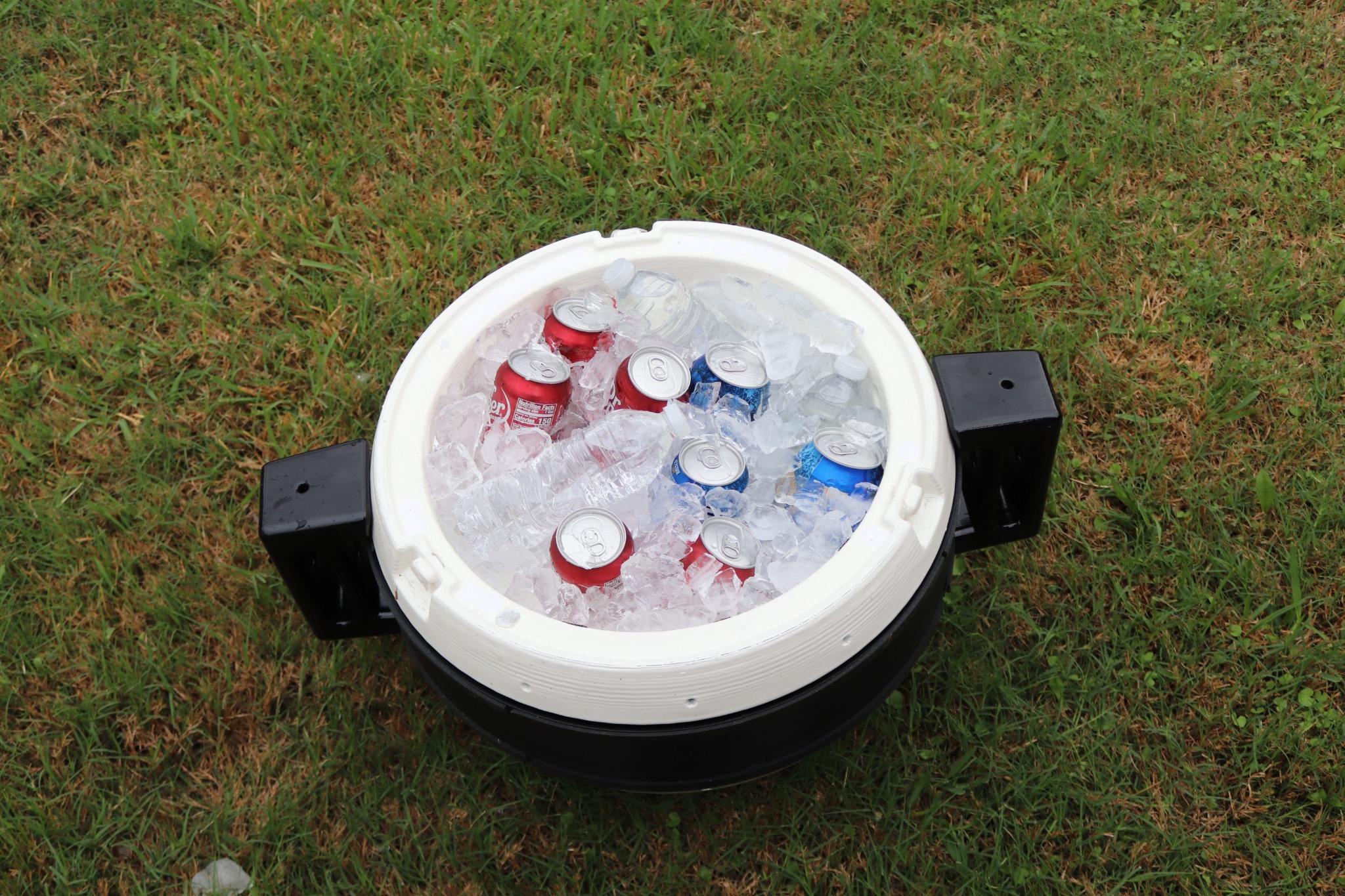 Pengo Cooler Ball filled with ice, cans, and bottles